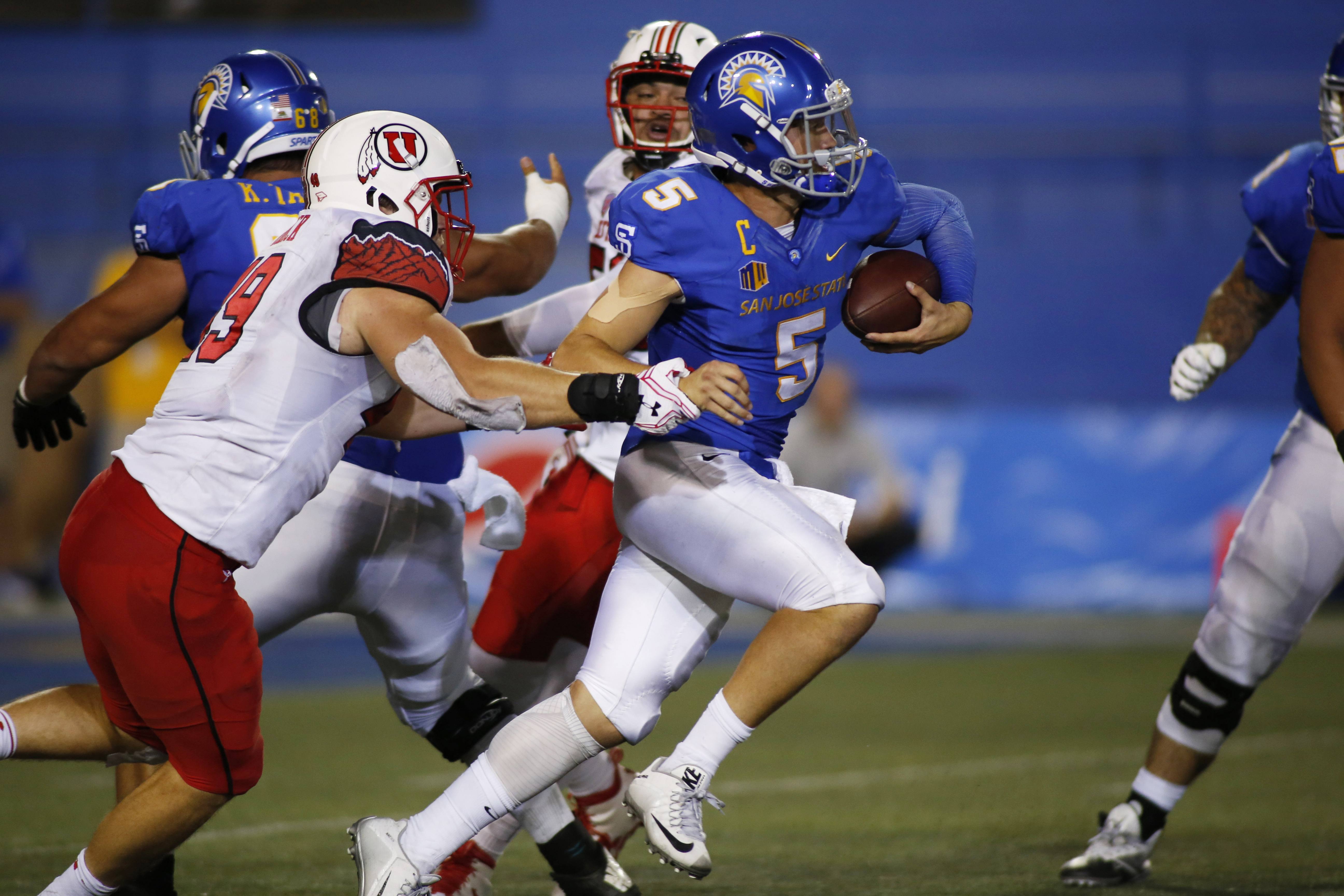 Sep 17, 2016; San Jose, CA, USA;  San Jose State Spartans quarterback Kenny Potter (5) runs with the ball as Utah Utes defensive end Hunter Dimick (49) grabs his arm during the game at Spartan Stadium. Mandatory Credit: Stan Szeto-USA TODAY Sports